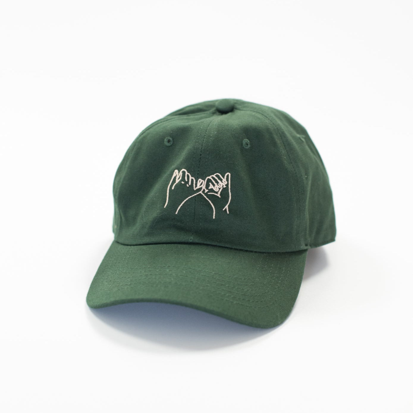 Green cap with a white logo on a white background